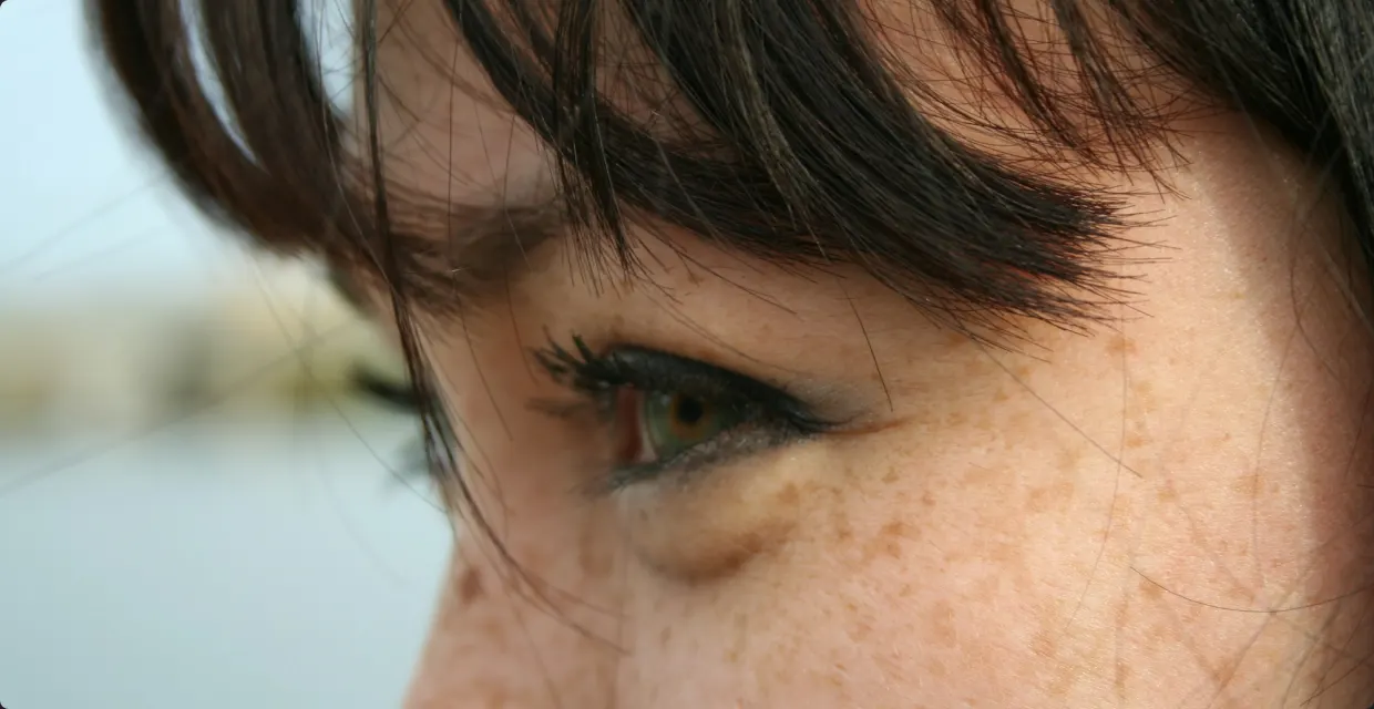 Close-up of a woman’s eye with soft, smudged eyeliner