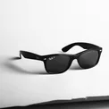 Black smart glasses on a white surface