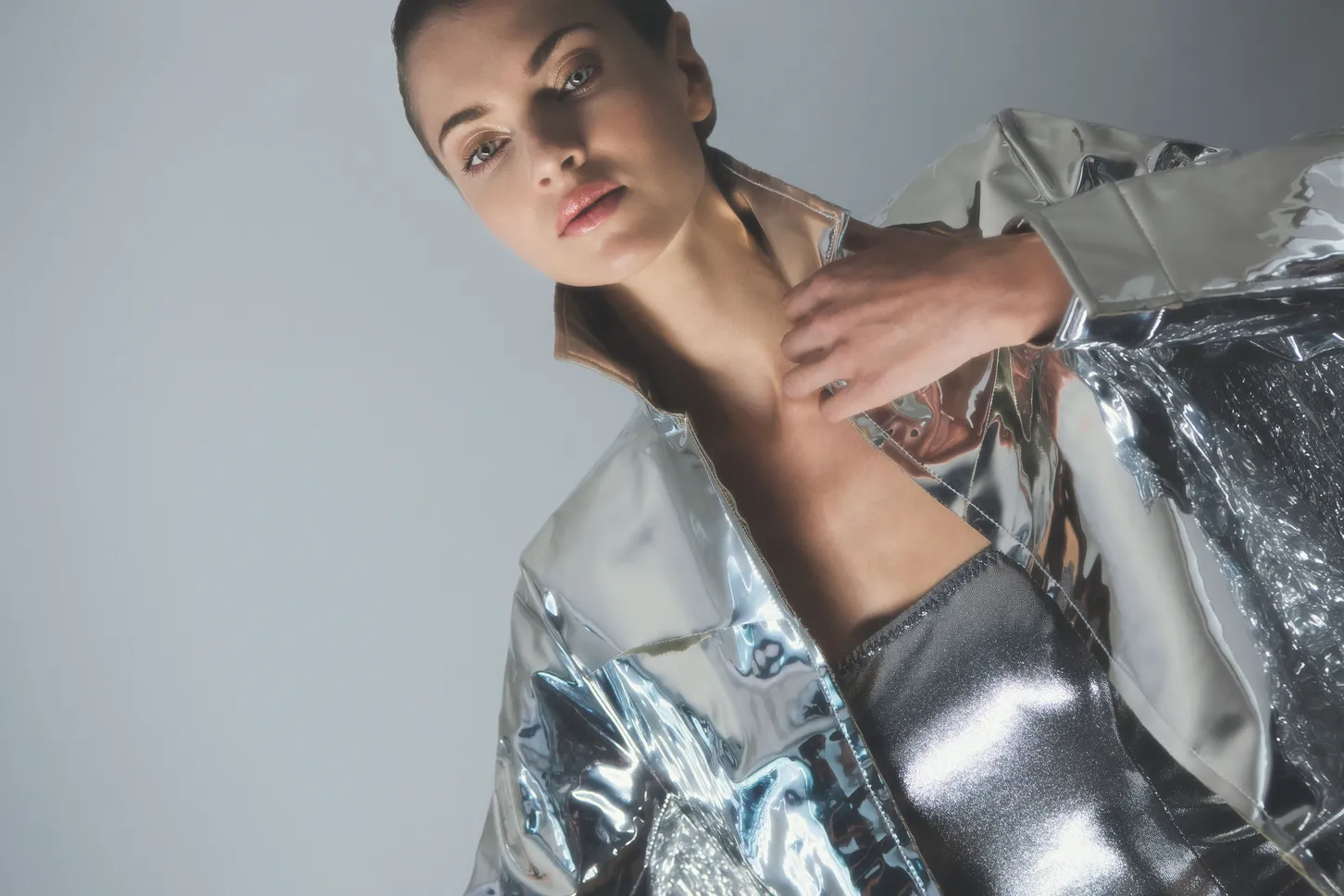 Woman in a silver metallic jacket and top