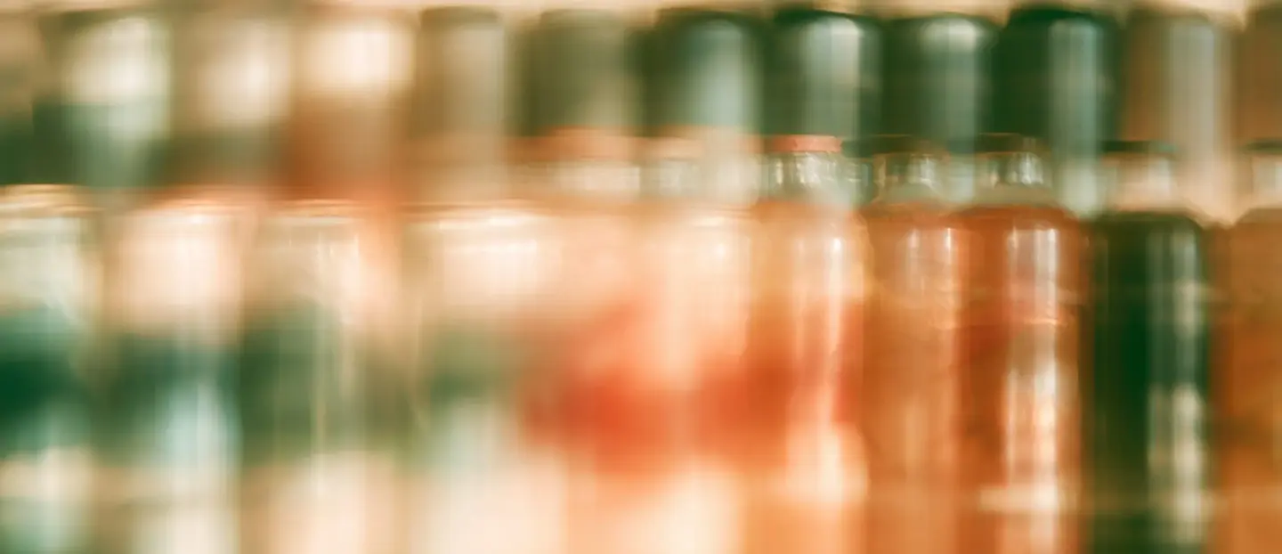 Shelf of bottled drinks in motion blur