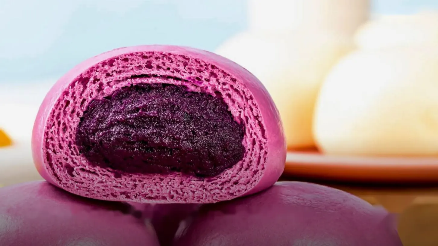 Purple ube bun cut open to show the filling