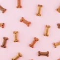 Bone-shaped treats on a pink background