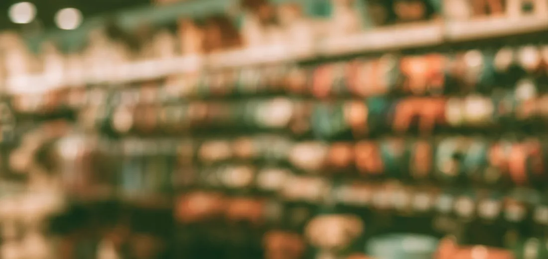Store shelves stocked with products, softly out of focus