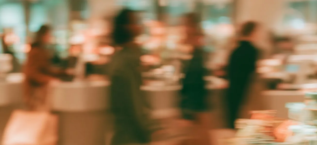 Shoppers moving through a store, in motion blur